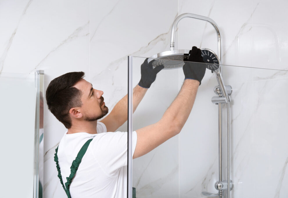 Plumber installing new shower head to save water at home